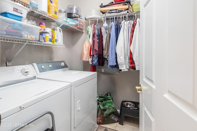 laundry room with washing machine and dryer and light tile patterned flooring