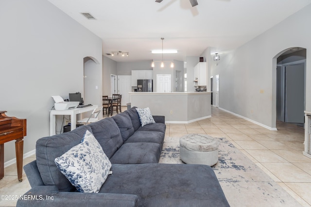 living room featuring ceiling fan and light tile patterned floors