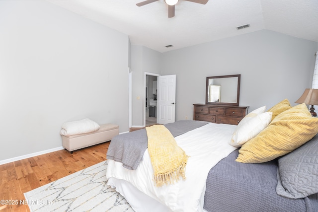 bedroom with hardwood / wood-style flooring, ceiling fan, and lofted ceiling