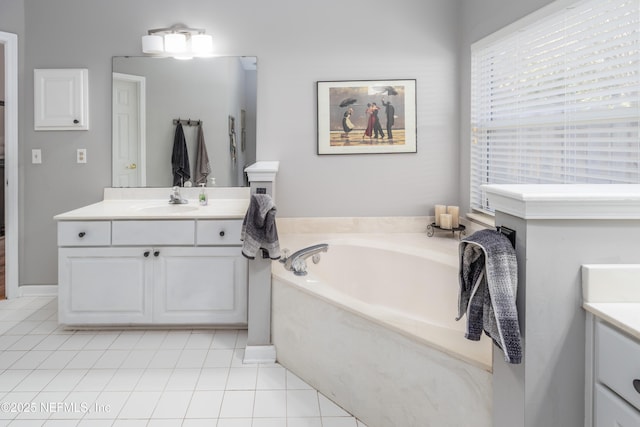 bathroom featuring a tub to relax in, tile patterned flooring, and vanity