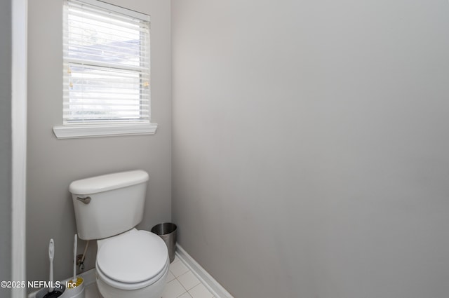 bathroom featuring tile patterned floors, toilet, and a wealth of natural light