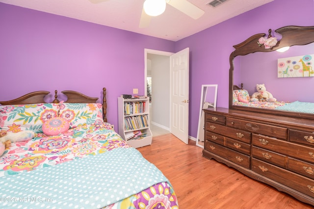 bedroom with ceiling fan and light hardwood / wood-style flooring