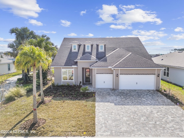 view of front of property with a front yard and a garage