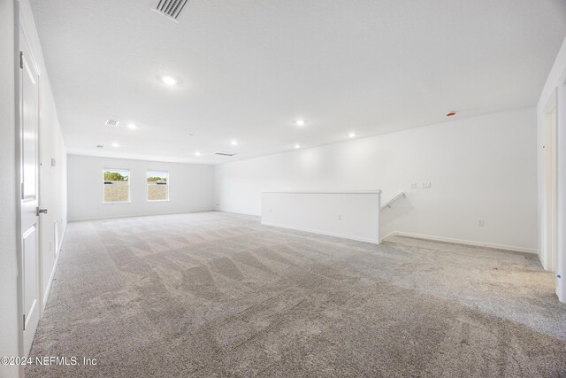 unfurnished living room with light carpet