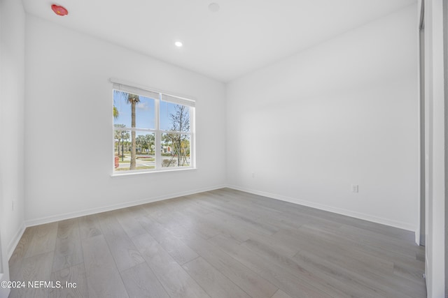 unfurnished room with light wood-type flooring