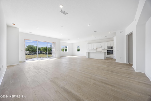 unfurnished living room with light hardwood / wood-style floors