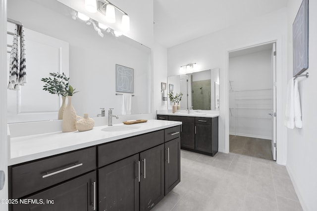 bathroom with tile patterned floors, walk in shower, and vanity