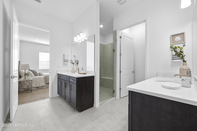 bathroom with a shower with door and vanity