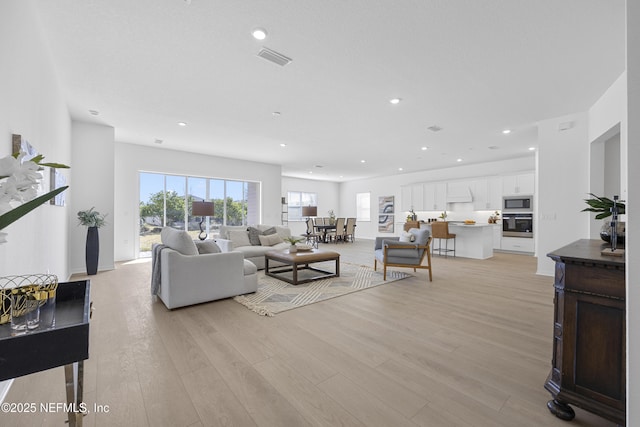 living room with light hardwood / wood-style flooring