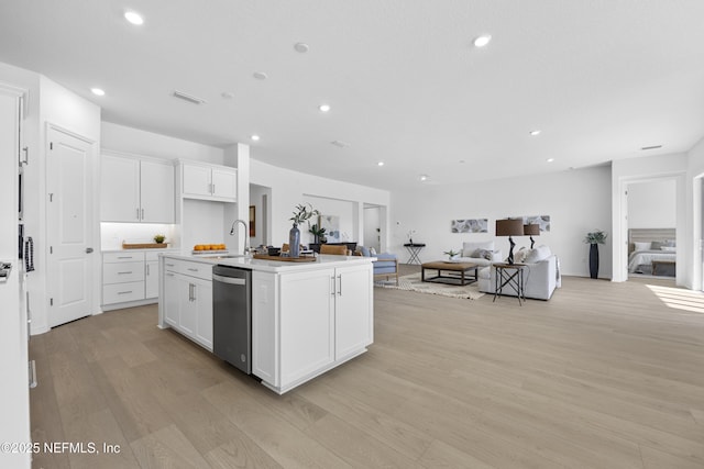 kitchen featuring sink, white cabinetry, a kitchen island with sink, and stainless steel dishwasher