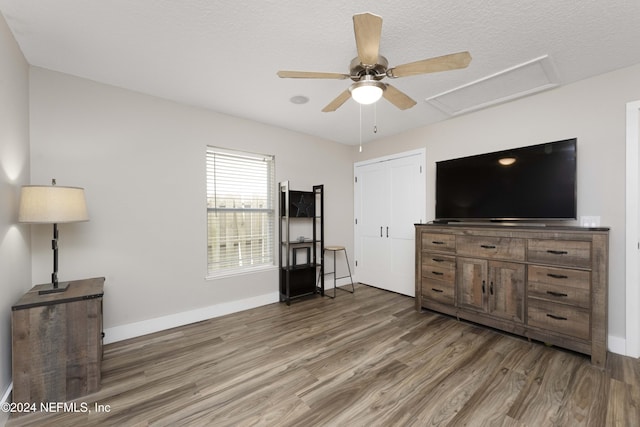 living room with a textured ceiling and dark hardwood / wood-style floors