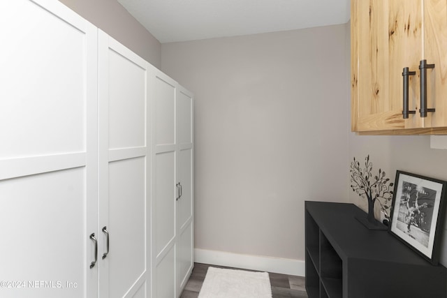 laundry room with dark hardwood / wood-style floors