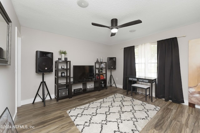 interior space with ceiling fan, dark hardwood / wood-style flooring, and a textured ceiling