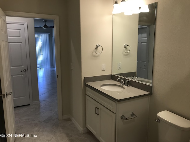 bathroom with ceiling fan, vanity, and toilet