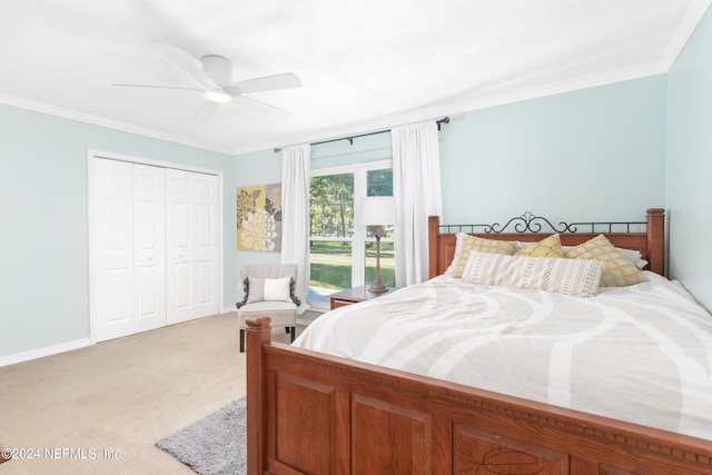 bedroom with ceiling fan, ornamental molding, light carpet, and a closet