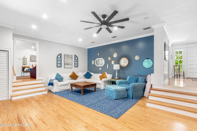 living room featuring hardwood / wood-style floors, ceiling fan, and ornamental molding