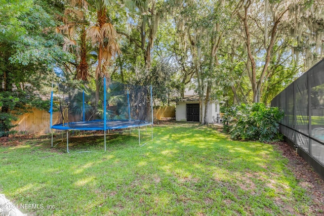 view of yard with a storage shed and a trampoline