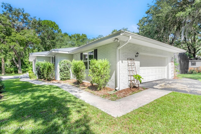 view of home's exterior with a garage and a yard