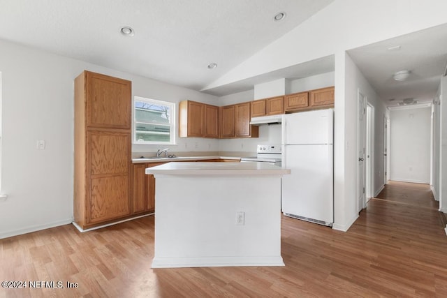 kitchen with sink, light hardwood / wood-style flooring, lofted ceiling, white appliances, and a kitchen island