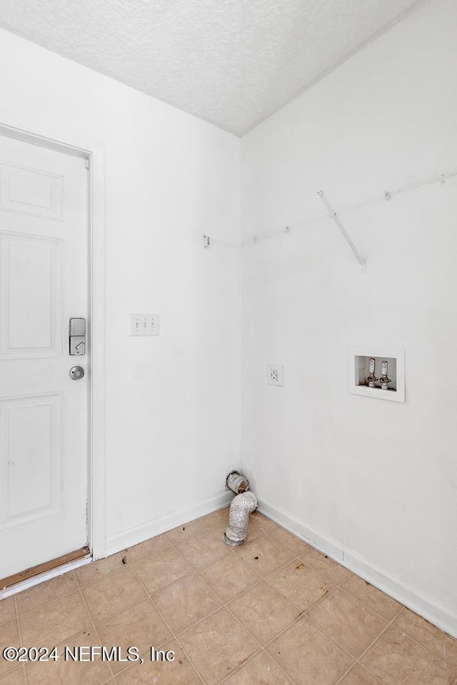 clothes washing area with a textured ceiling and hookup for a washing machine