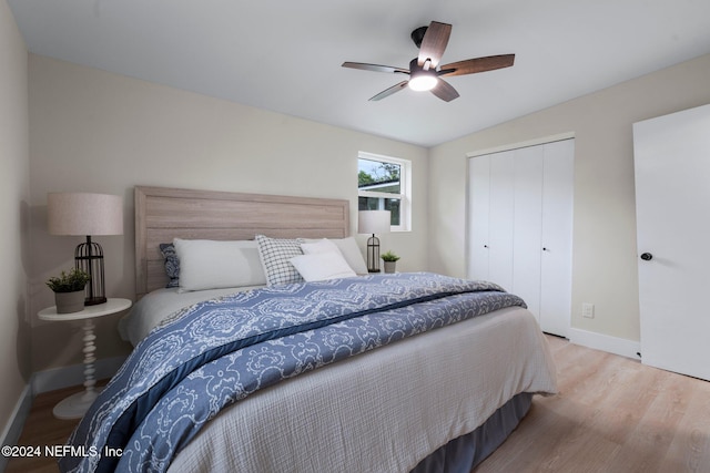 bedroom featuring light wood-type flooring, a closet, vaulted ceiling, and ceiling fan