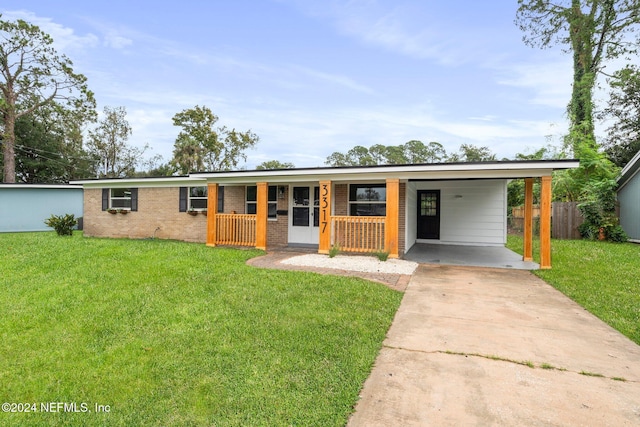 ranch-style home with covered porch, a front lawn, and a carport