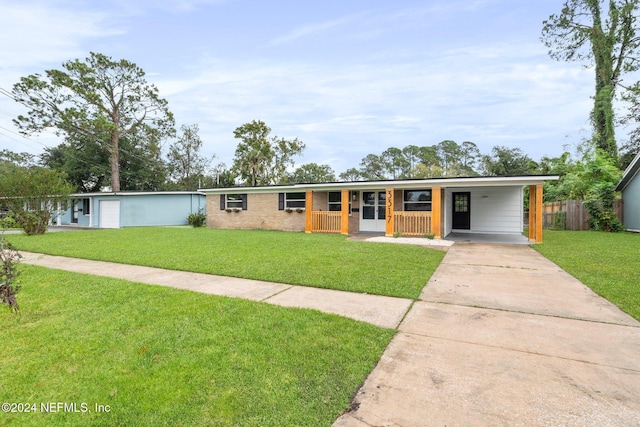 ranch-style house featuring a front lawn, covered porch, and a carport