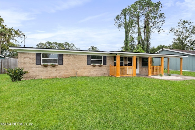 ranch-style house featuring a front lawn and a porch