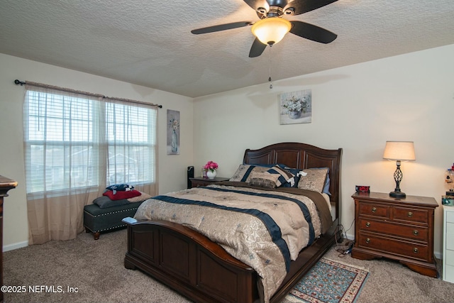 bedroom with multiple windows, ceiling fan, light colored carpet, and a textured ceiling