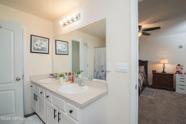 bathroom featuring ceiling fan, a textured ceiling, and vanity