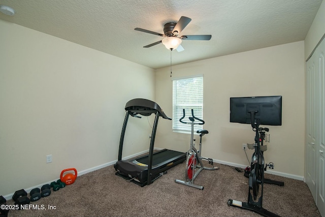 workout room with ceiling fan and a textured ceiling