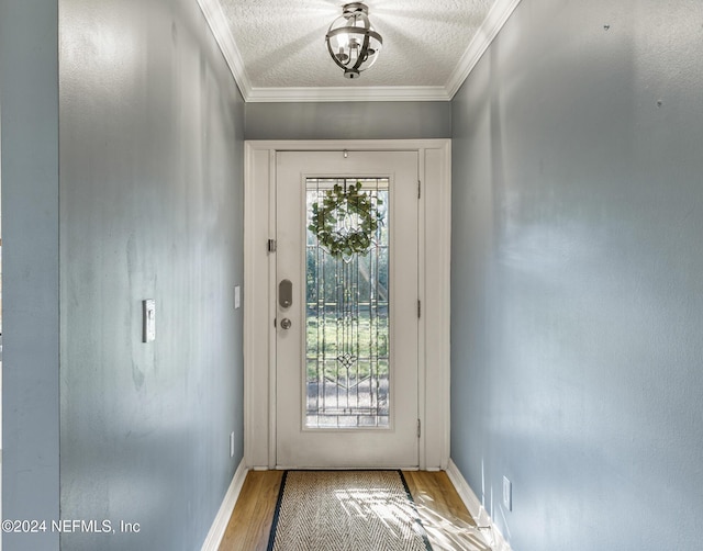 entryway featuring a wealth of natural light, crown molding, a textured ceiling, and hardwood / wood-style flooring