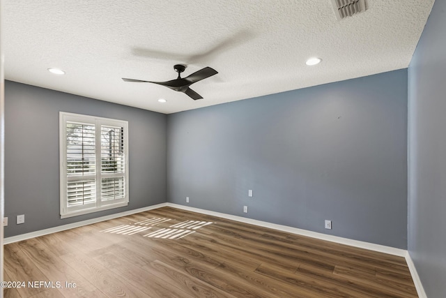 unfurnished room with a textured ceiling, hardwood / wood-style flooring, and ceiling fan