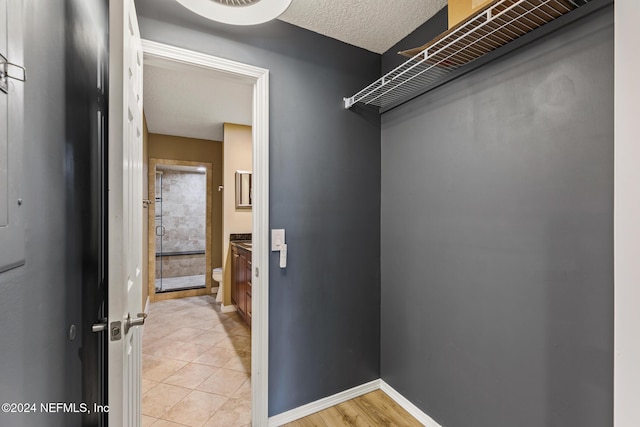 spacious closet featuring light tile patterned floors