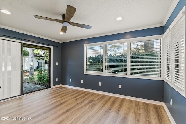 spare room featuring ceiling fan, ornamental molding, a textured ceiling, and light hardwood / wood-style flooring