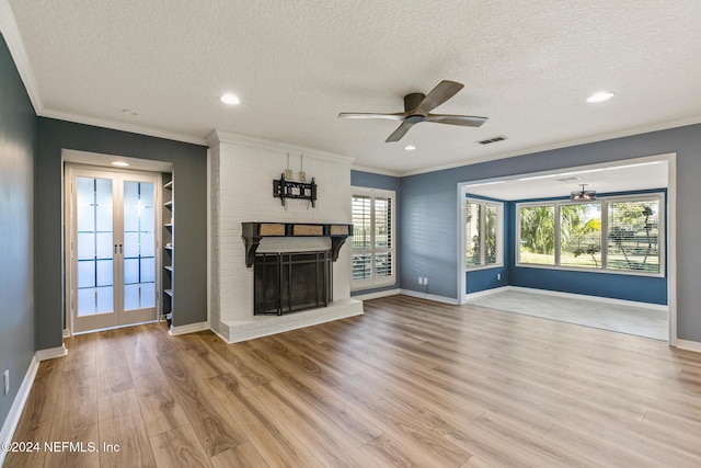 unfurnished living room with ceiling fan, crown molding, light wood-type flooring, and a textured ceiling