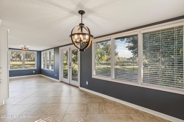 interior space featuring a notable chandelier and a textured ceiling