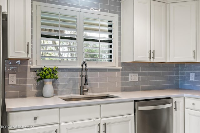 kitchen with backsplash, white cabinetry, dishwasher, and sink