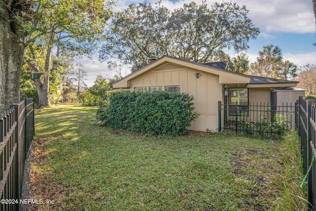 view of home's exterior with a yard