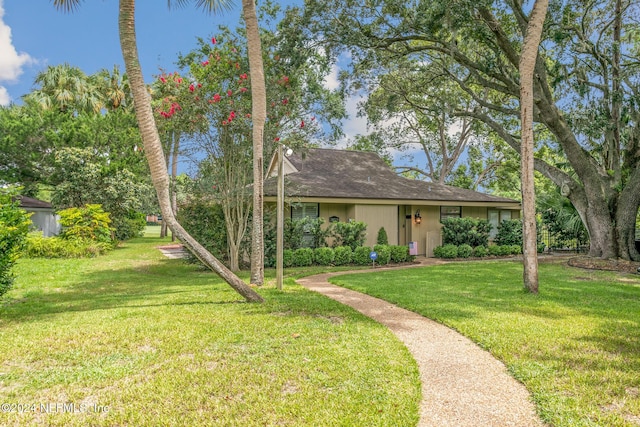 single story home with a front lawn