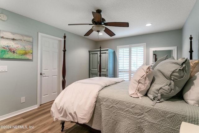 bedroom featuring ceiling fan, a textured ceiling, and hardwood / wood-style flooring