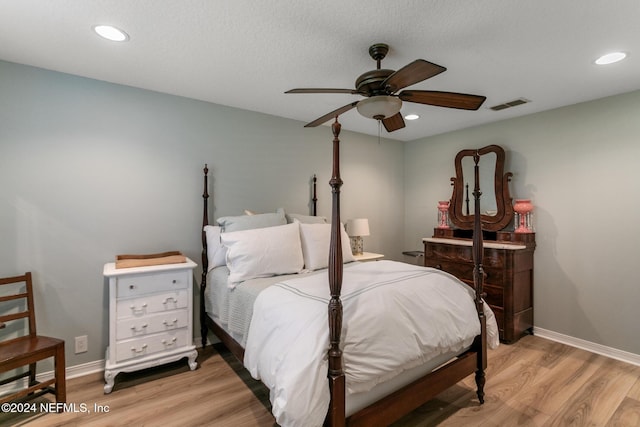 bedroom with light hardwood / wood-style flooring and ceiling fan