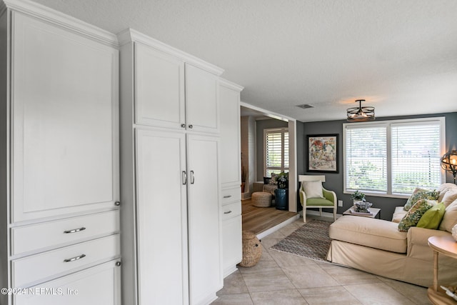 living room with light tile patterned flooring and a textured ceiling