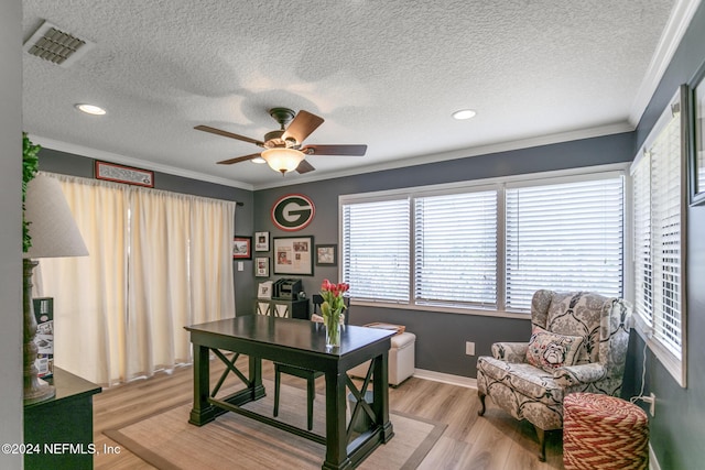 office area with ceiling fan, ornamental molding, a textured ceiling, and light hardwood / wood-style flooring