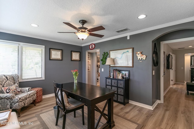 dining room with ceiling fan, wood-type flooring, and ornamental molding