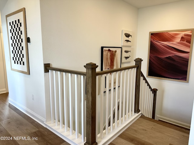 stairs featuring hardwood / wood-style floors