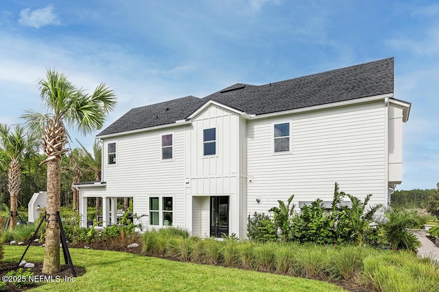 rear view of house featuring a yard