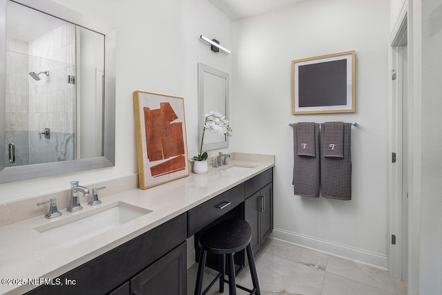 bathroom featuring tile patterned flooring, an enclosed shower, and vanity