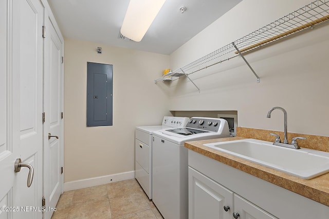 clothes washing area featuring sink, cabinets, electric panel, light tile patterned flooring, and washer and dryer