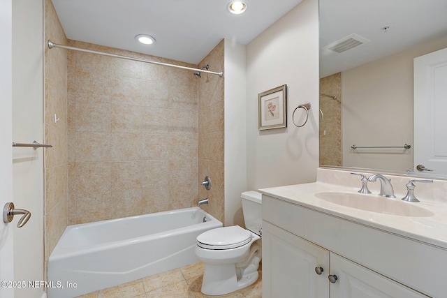 full bathroom with vanity, tile patterned floors, tiled shower / bath combo, and toilet